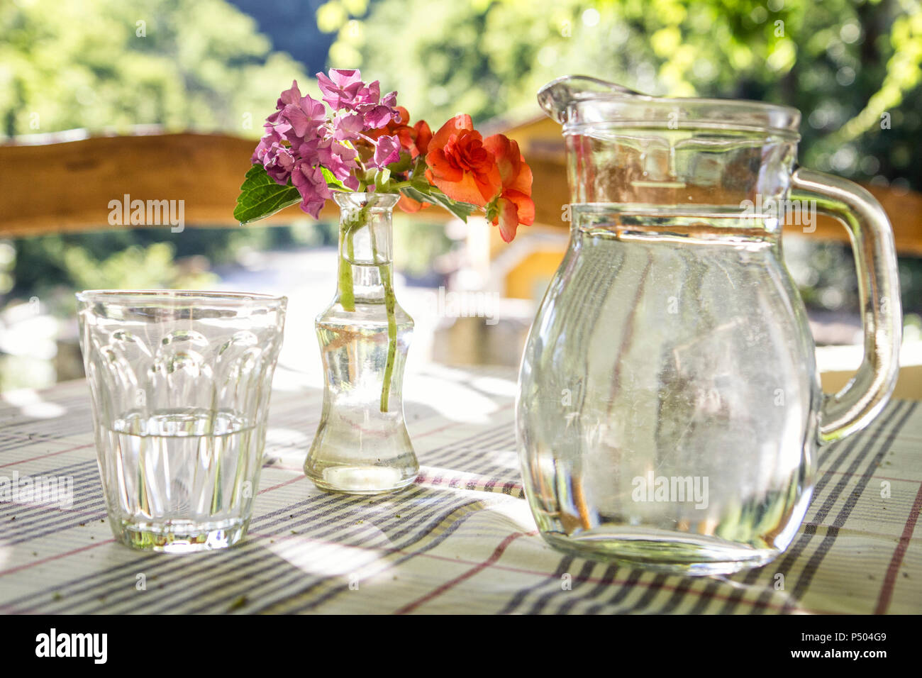 Glass jar and glass of water on table Stock Photo Alamy