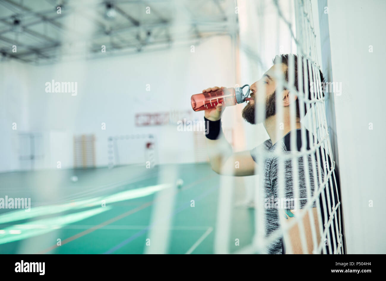 Basketball player drinking from plastic bottle Stock Photo