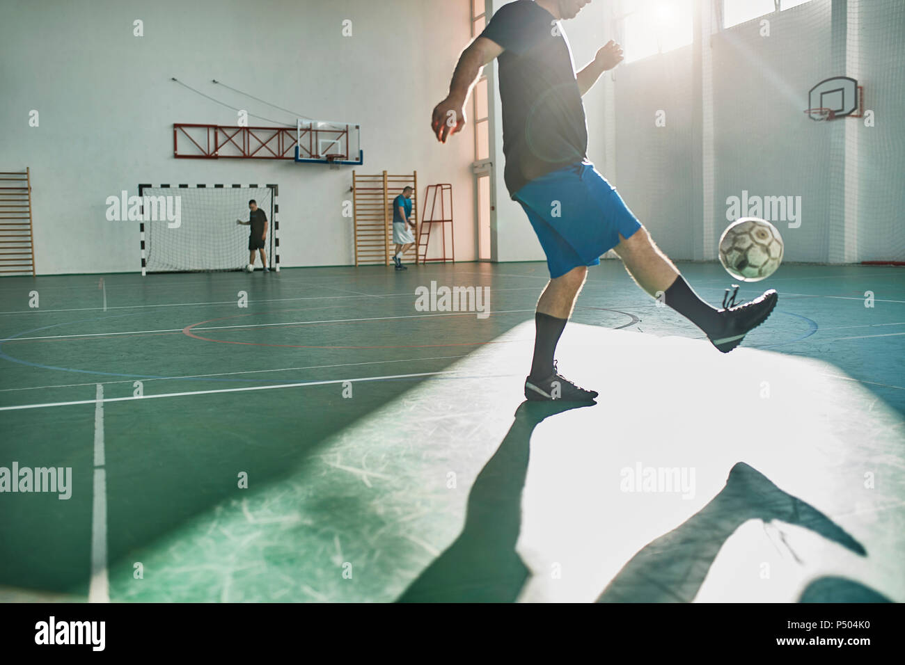 Indoor soccer player balancing ball hires stock photography and images