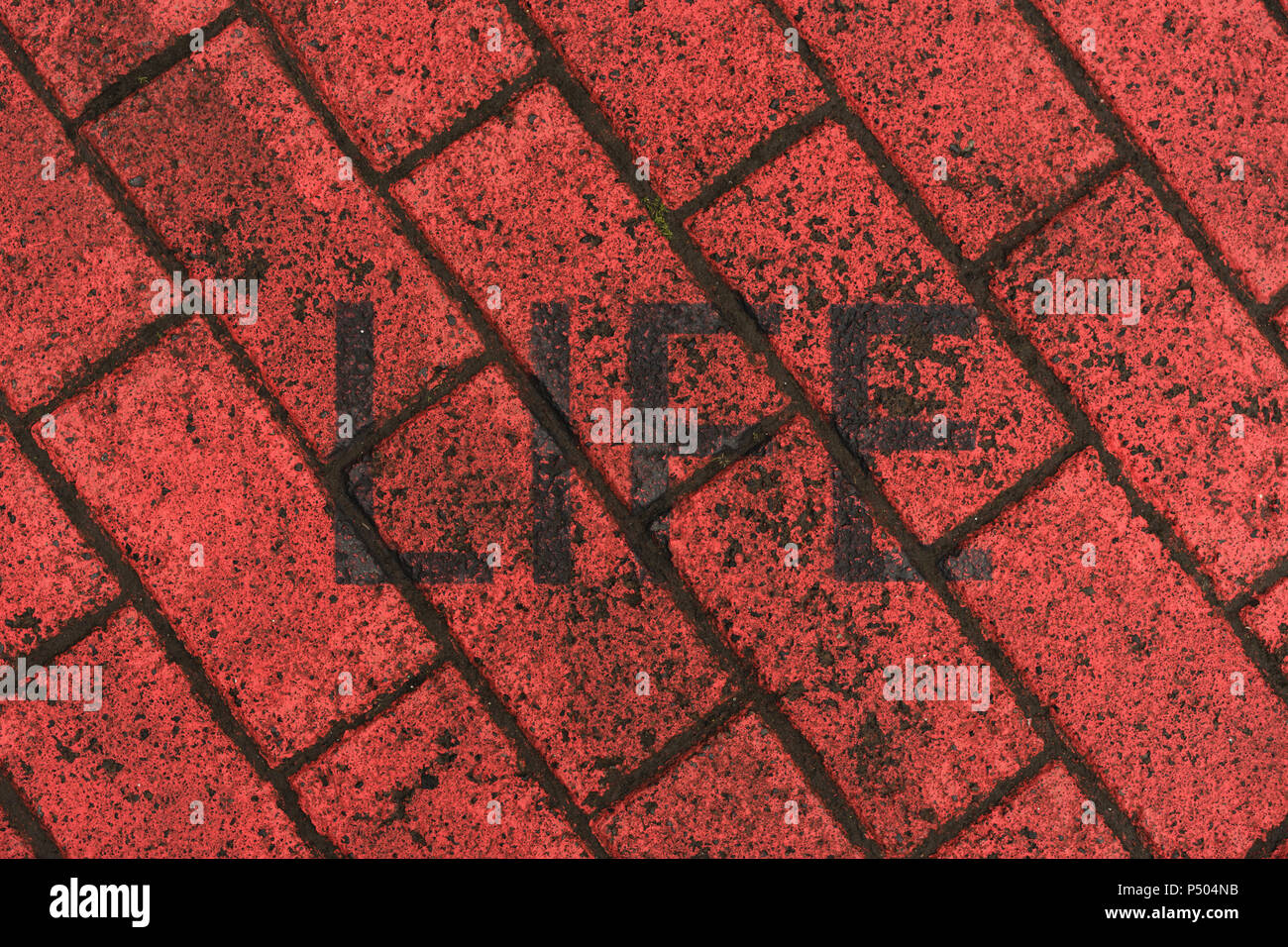 Word 'Life' stenciled on red pavement Stock Photo