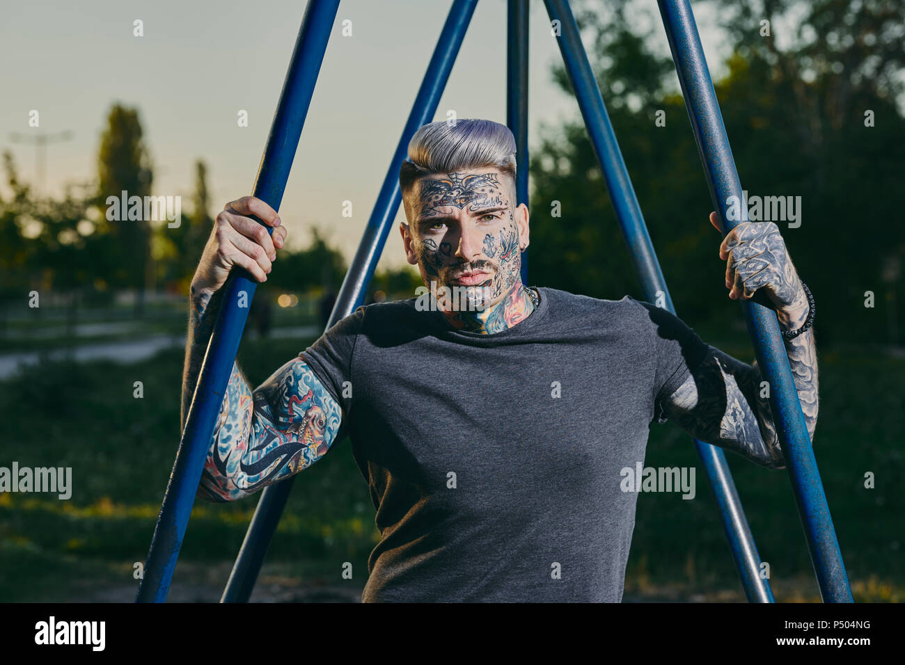 Portrait of tattooed young man outdoors Stock Photo