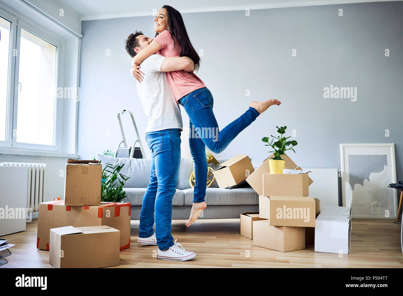 Happy couple celebrating moving in together Stock Photo