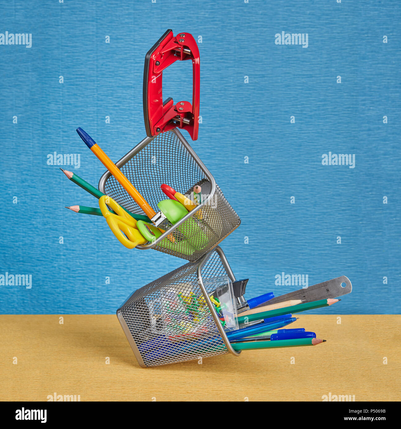Two desktop stands for school supplies are filled with stationery in a zero-gravity environment. Stock Photo
