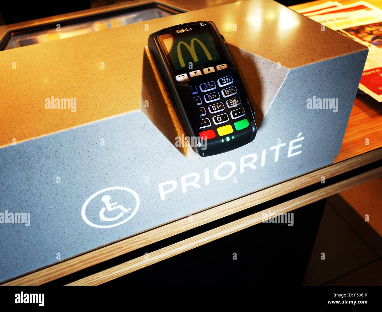 Priority fast order machines plus for disabled the low access helps at McDonald's Takeaway in Saint-Étienne-du-Rouvray, France Stock Photo