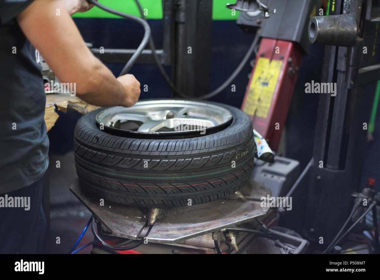 Professional mechanic using machine for tyre change Stock Photo Alamy