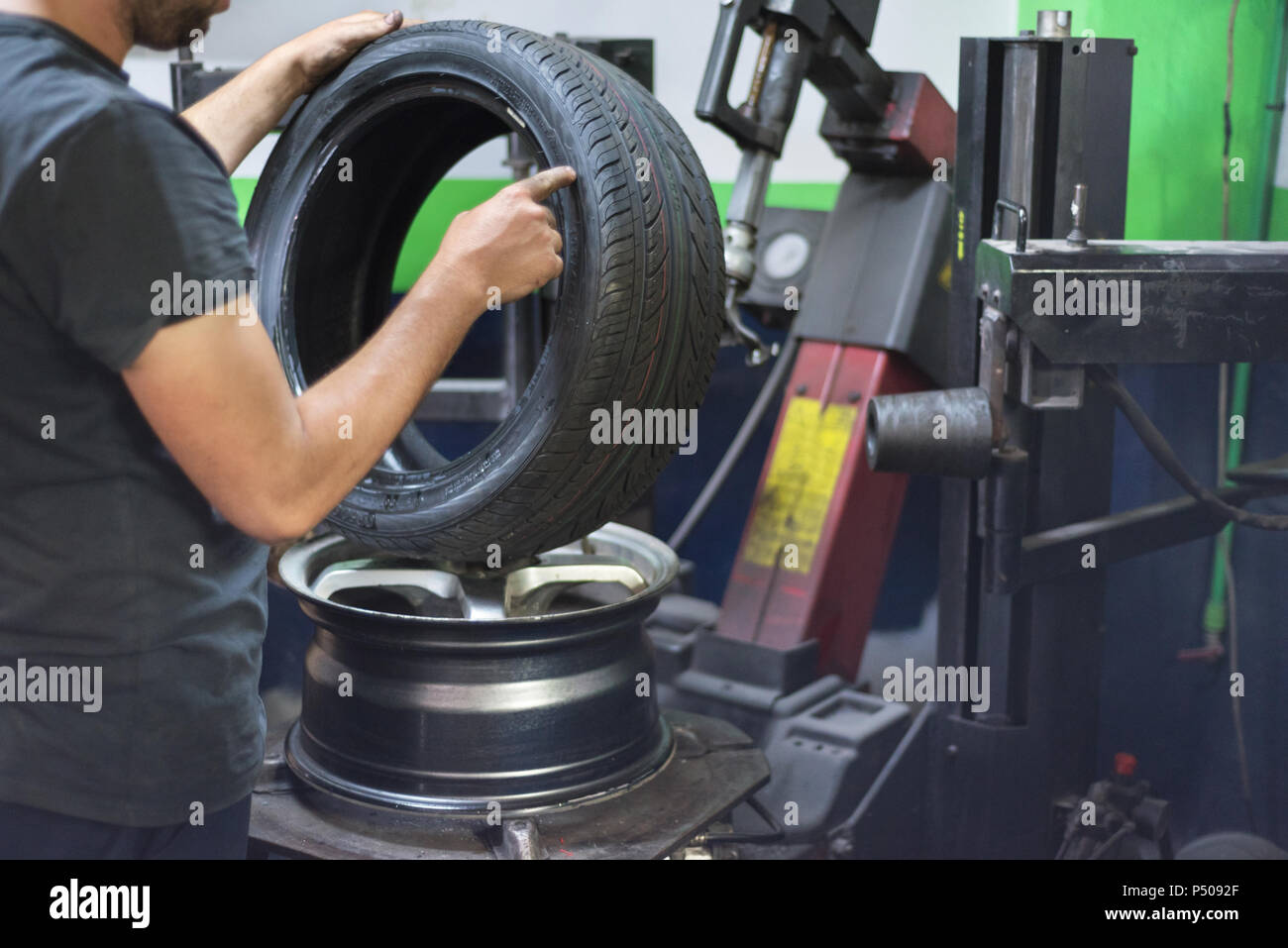 Professional mechanic using machine for tyre change Stock Photo Alamy