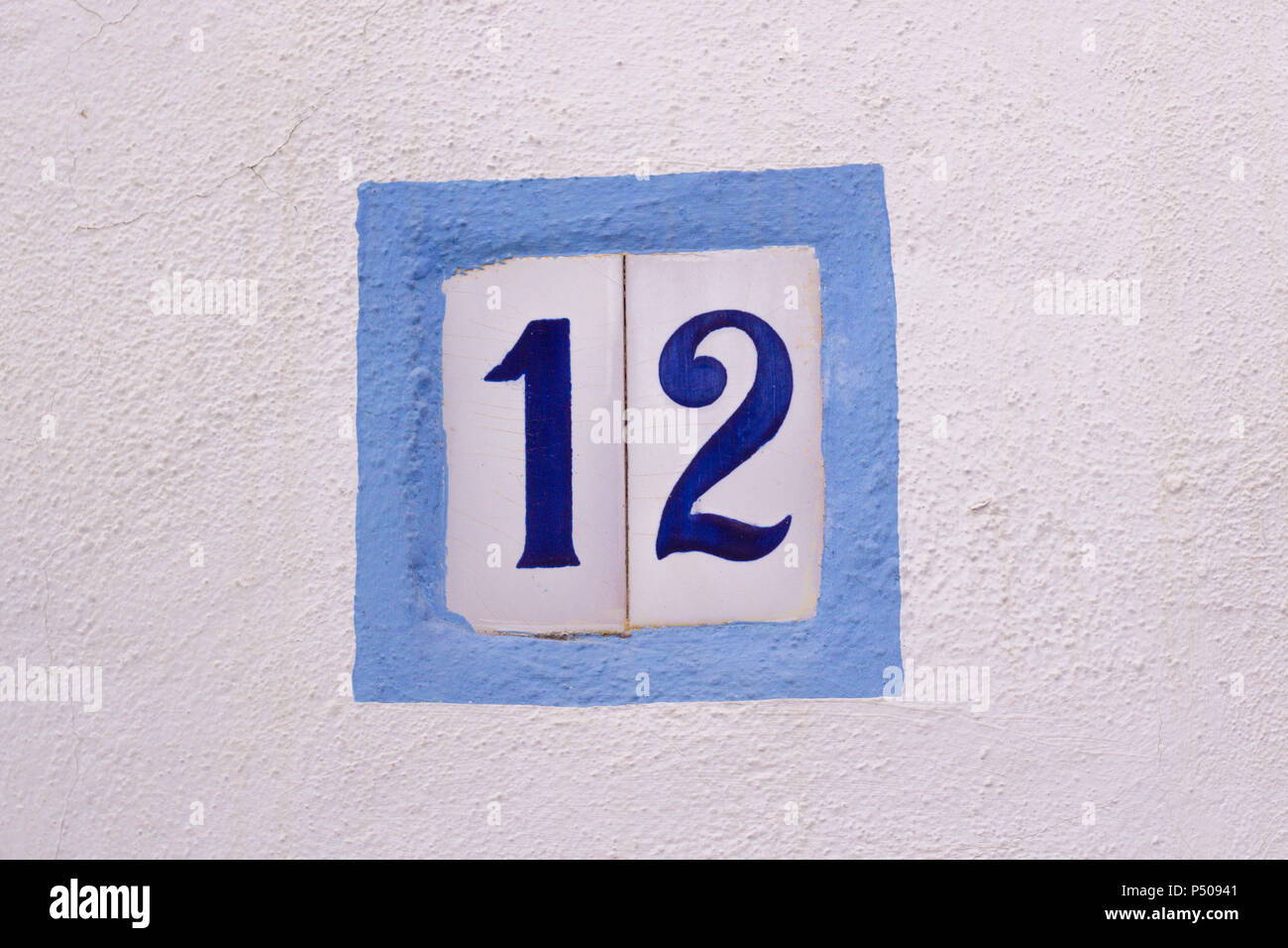 House number on ceramic tiles on white wall Stock Photo
