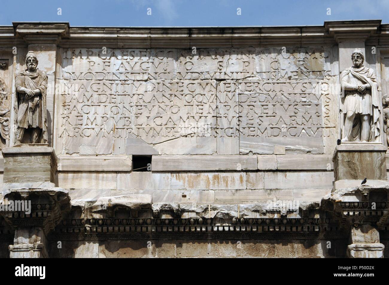 Roman Art. Arch of Constantine. Triumphal arch erected in the 4th century (315) by the Senate in honor of the Emperor Constantine after his victory over Maxentius at the Battle of Milvian Bridge (312). Latin inscription. Rome. Italy. Stock Photo