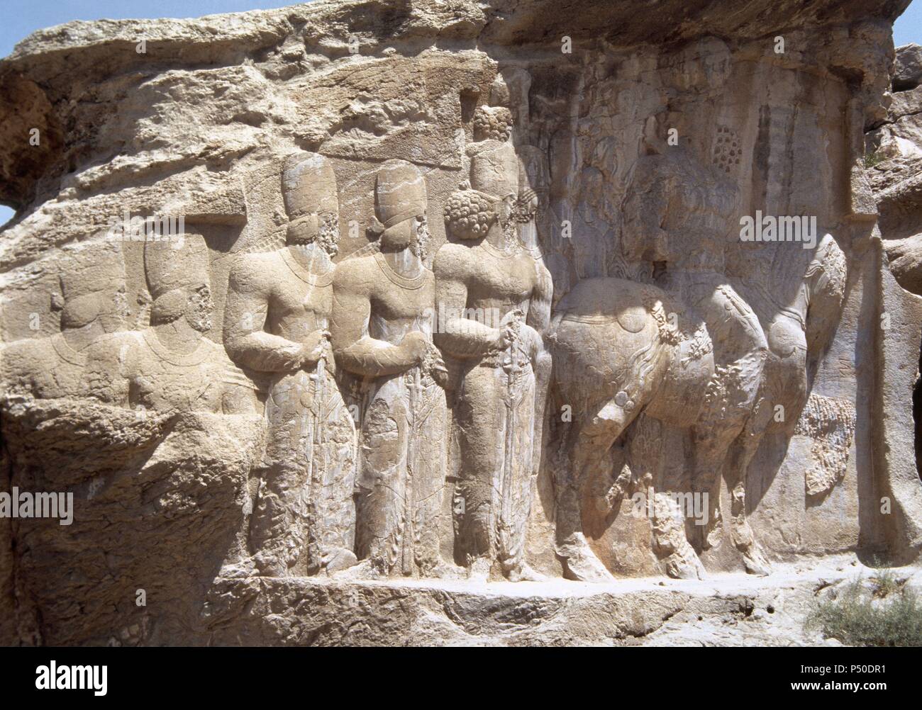 Sasanians. Relief of Shapur's Parade depicting the King Shapur I riding a horse, folllowed by his sons and other characters. 3rd century. It celebrates the king's military victory in 244 over the Roman emperor Valerian and Philip the Arab. Naqsh-e Rajab. Fars Province, Iran (Old Persia). Stock Photo