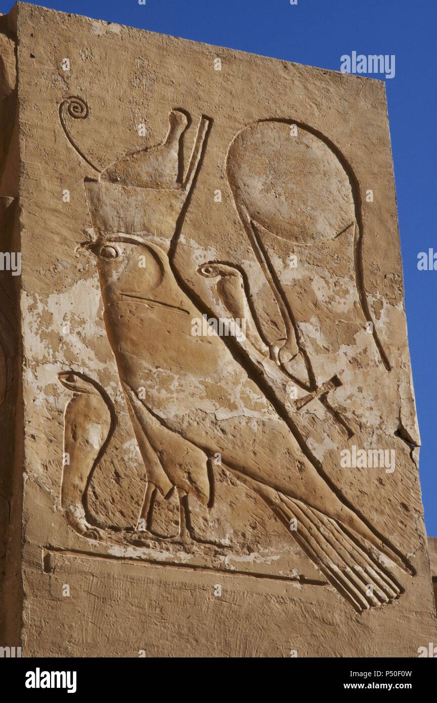 Relief with an inscription in hieroglyphics. Solar disk with snake (cobra) with the ankh around his neck and Falcon with double crown over a cobra. Temple of Hatshepsut. 18th Dynasty. New Kingdom. Deir el-Bahari. Egypt. Stock Photo