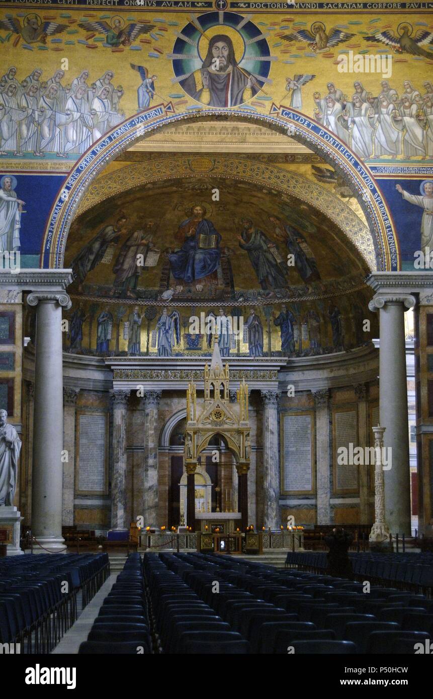 Italy. Rome. Basilica of Saint Paul Outside the Walls. Apse mosaic (1200) by Venetian artists. Christ in flanked by the Apostles Peter, Paul, Andrew and Luke and Arnolfo di Cambio's Tabernacle, 1285. Stock Photo