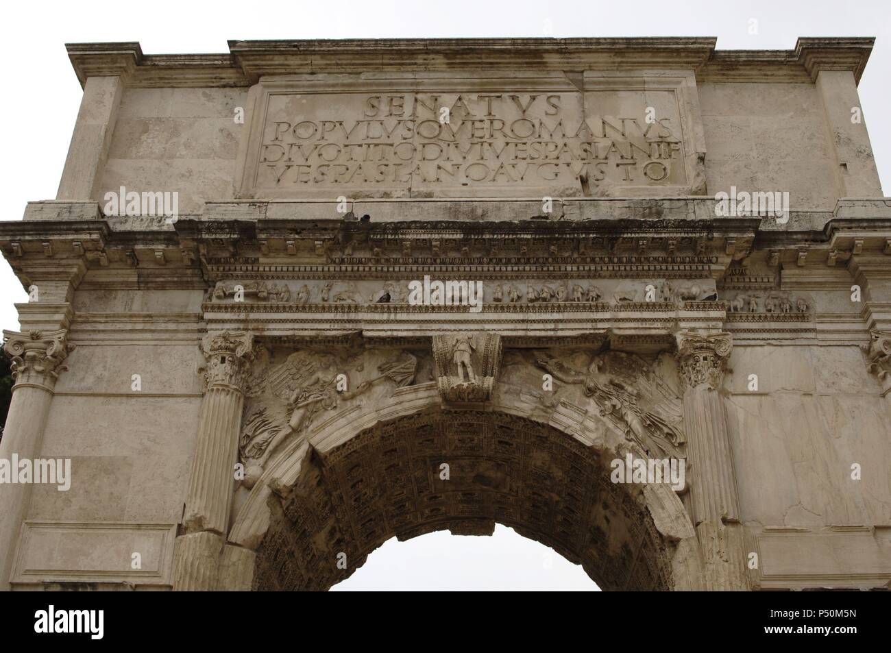 Roman Art. Arch of Titus. Erected in the year 81 to commemorate the conquest of Titus against the Jews. It features carved scenes of the conquest and subsequent destruction of Jerusalem (AD 70). Via Sacra. Roman Forum. Partial view. Rome. Italy. Stock Photo