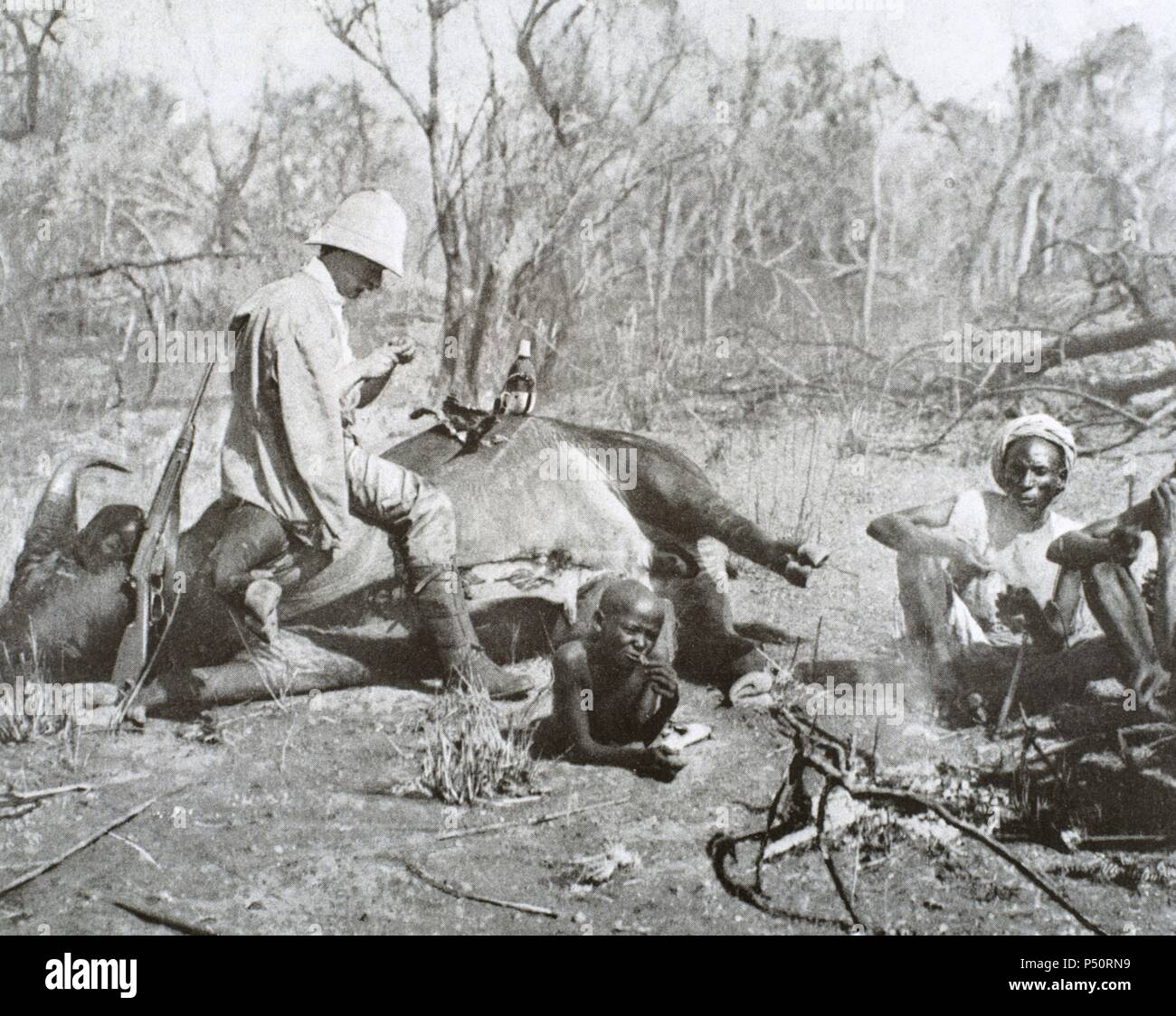 Colonialism. Africa. Eating after the buffalo hunt, 1908. Stock Photo