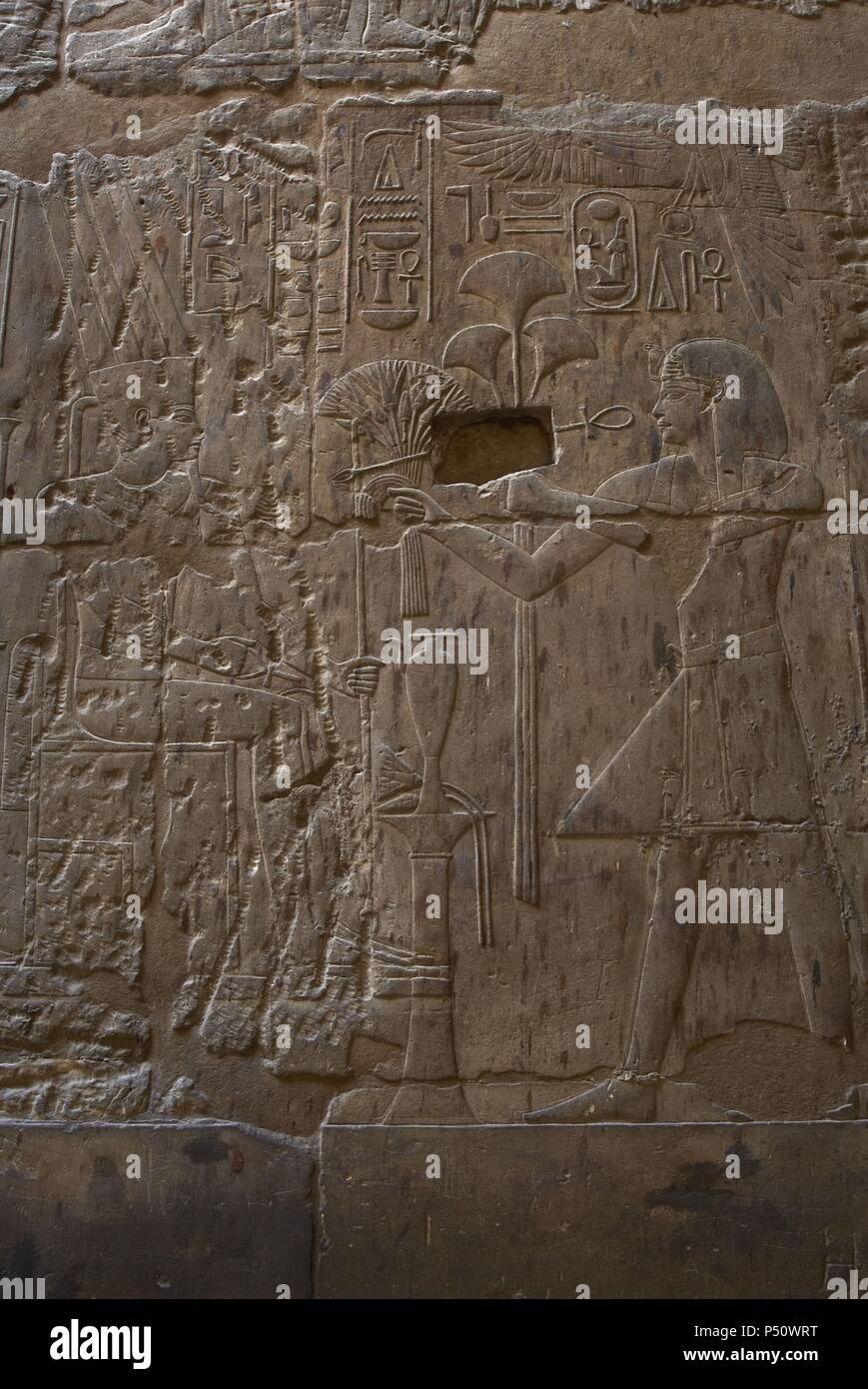 Pharaoh Amenhotep III  offering to the god Amun lotus flowers and papyrus. New Kingdom. Temple of Luxor. Egypt. Stock Photo