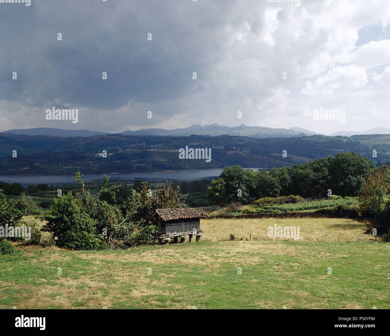 Spain. Galicia. Overview of a typical galician landscape with Reservoir Das Conchas in the background. Near Santa Comba de Bande. Stock Photo