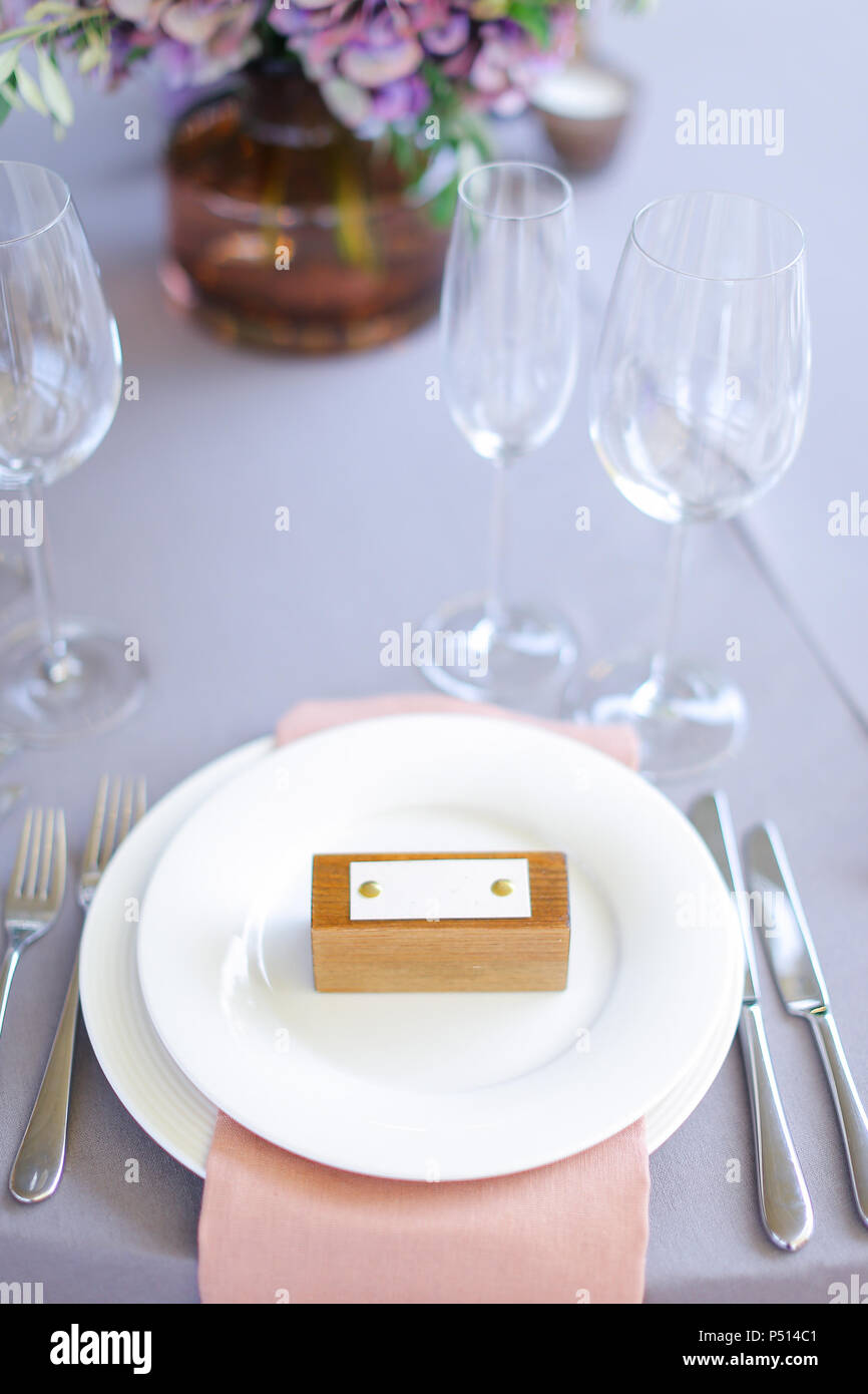 Closeup plate, fork and knife on served table. Stock Photo