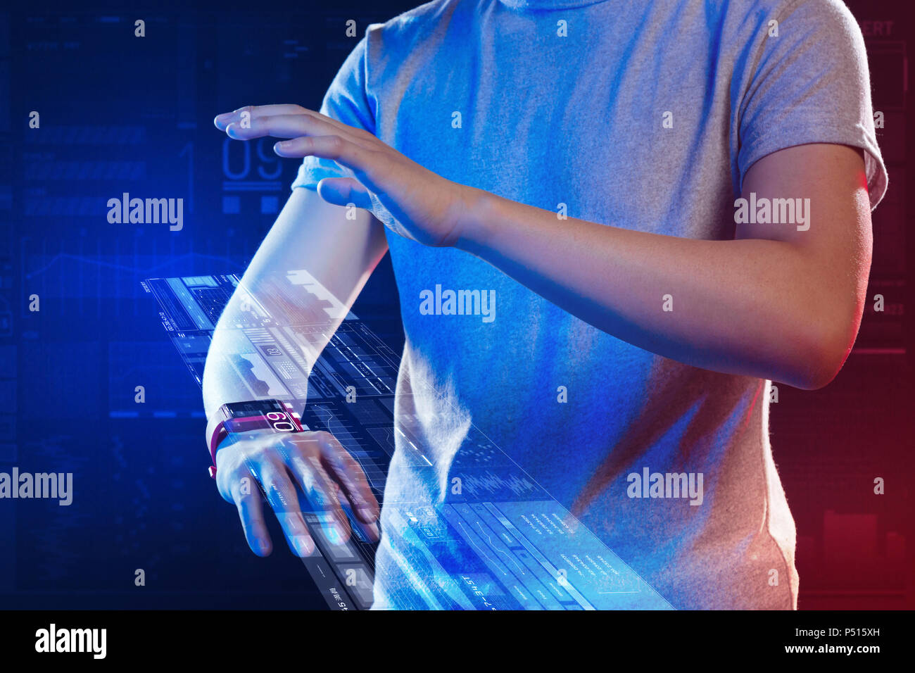 Calm web developer carefully touching the hologram while working Stock ...