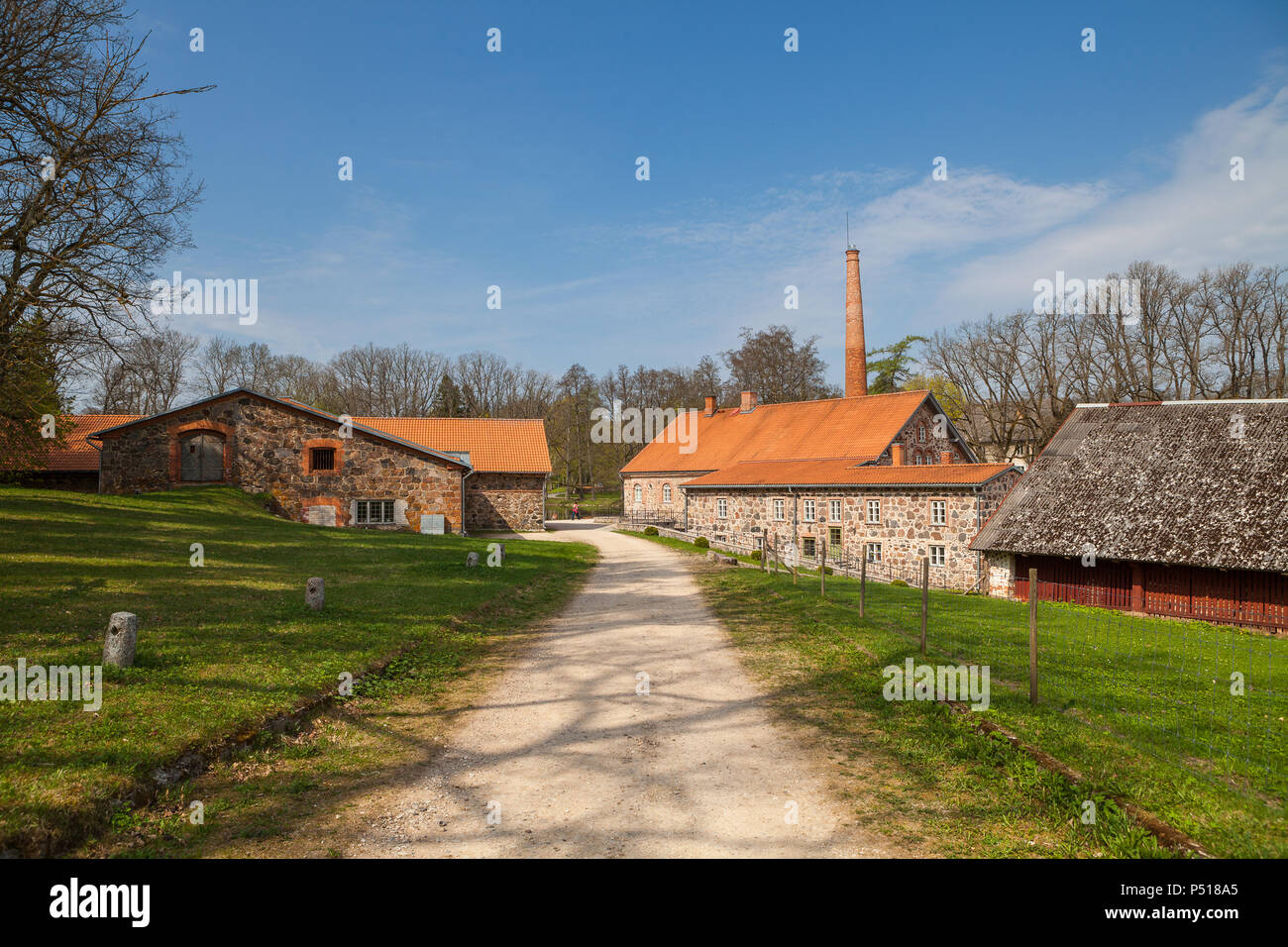 Old Olustvere manor park in the summer time. The manor's vodka distillery buildings located in the middle of Estonia Stock Photo