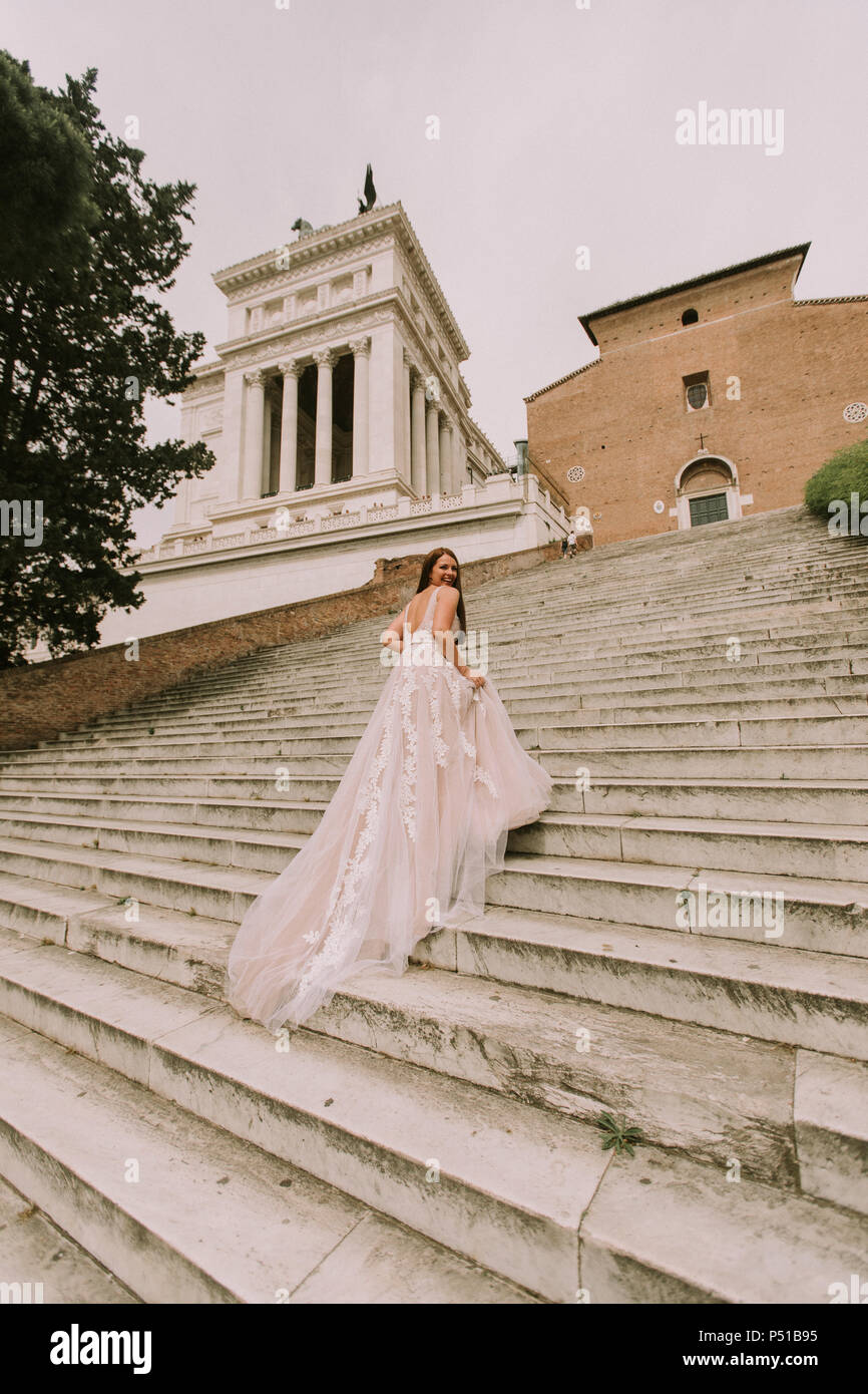 Bride In Wedding Dress On Stairs Of Cordonata Capitolina In Rome