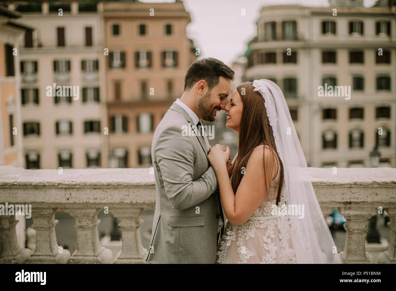 Newly married bride and groom posing together with family outdoors under  vine covered pergola Stock Photo - Alamy