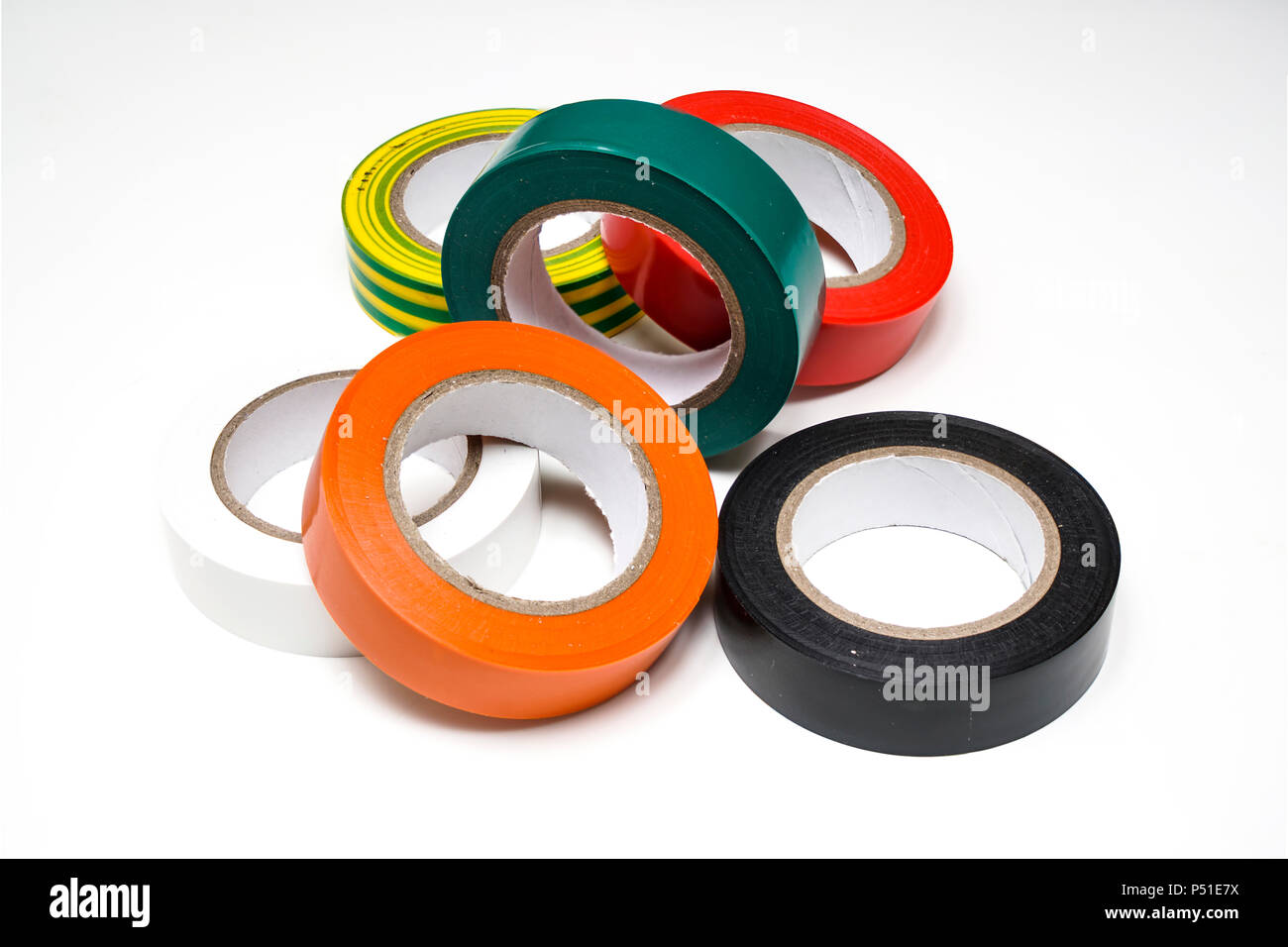 some rolls of colored insulating tapes on a white surface Stock Photo
