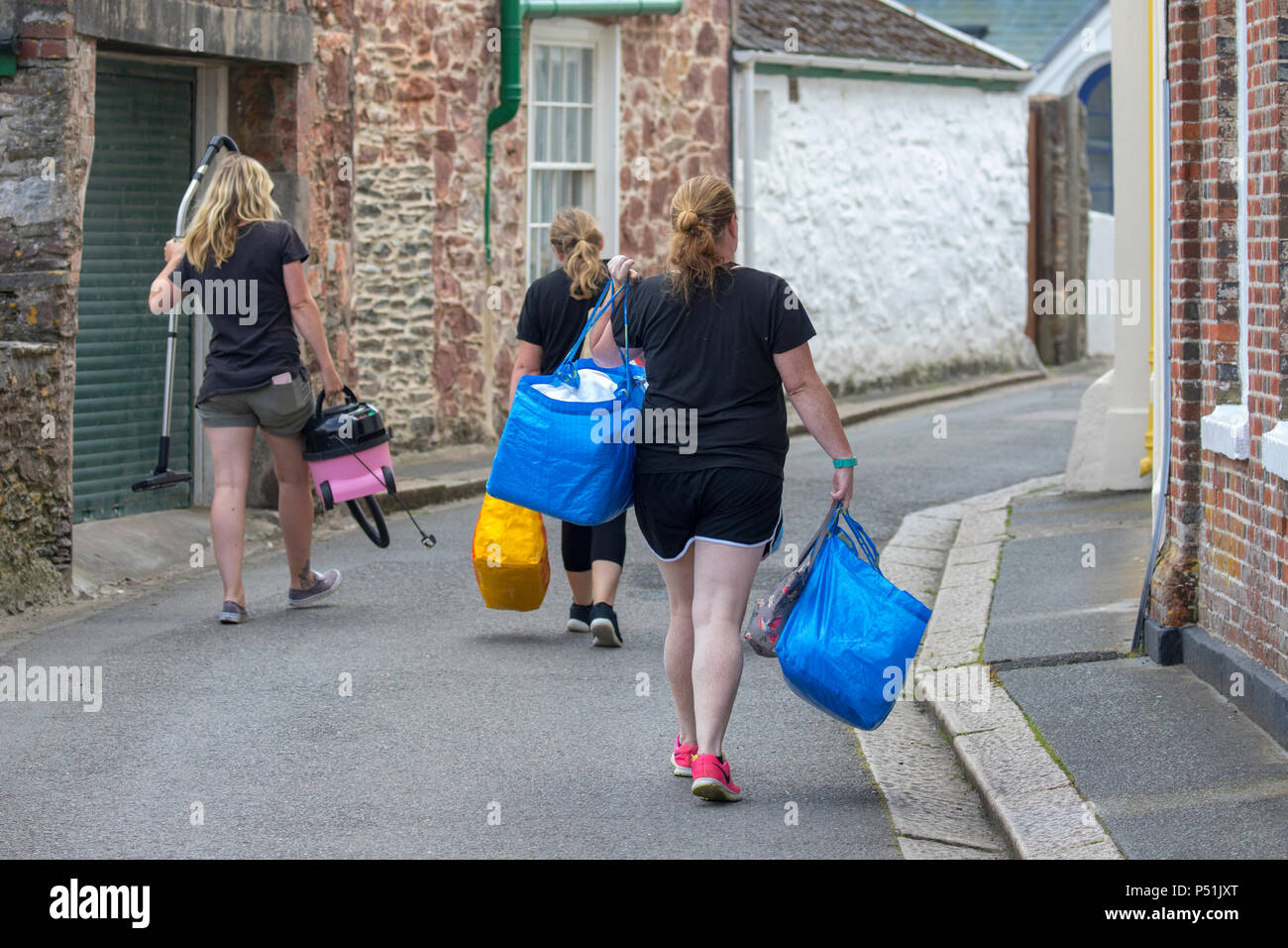 House Keeping maids walking along a narrow Cornish lane between Kingsand and Cawsand on their rounds of cleaning guest hotels, self catering houses Stock Photo