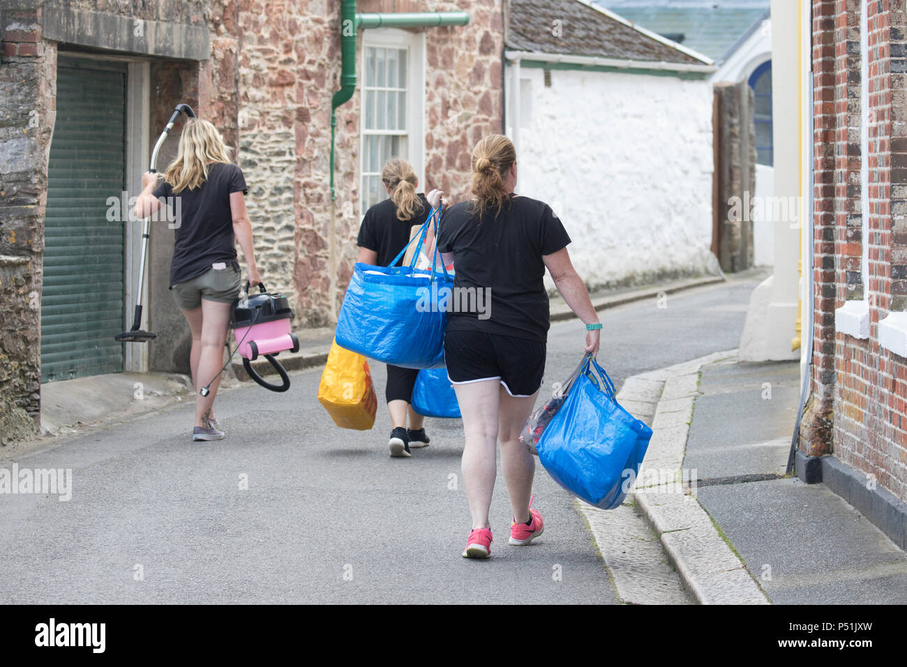 House Keeping maids walking along a narrow Cornish lane between Kingsand and Cawsand on their rounds of cleaning guest hotels, self catering houses Stock Photo