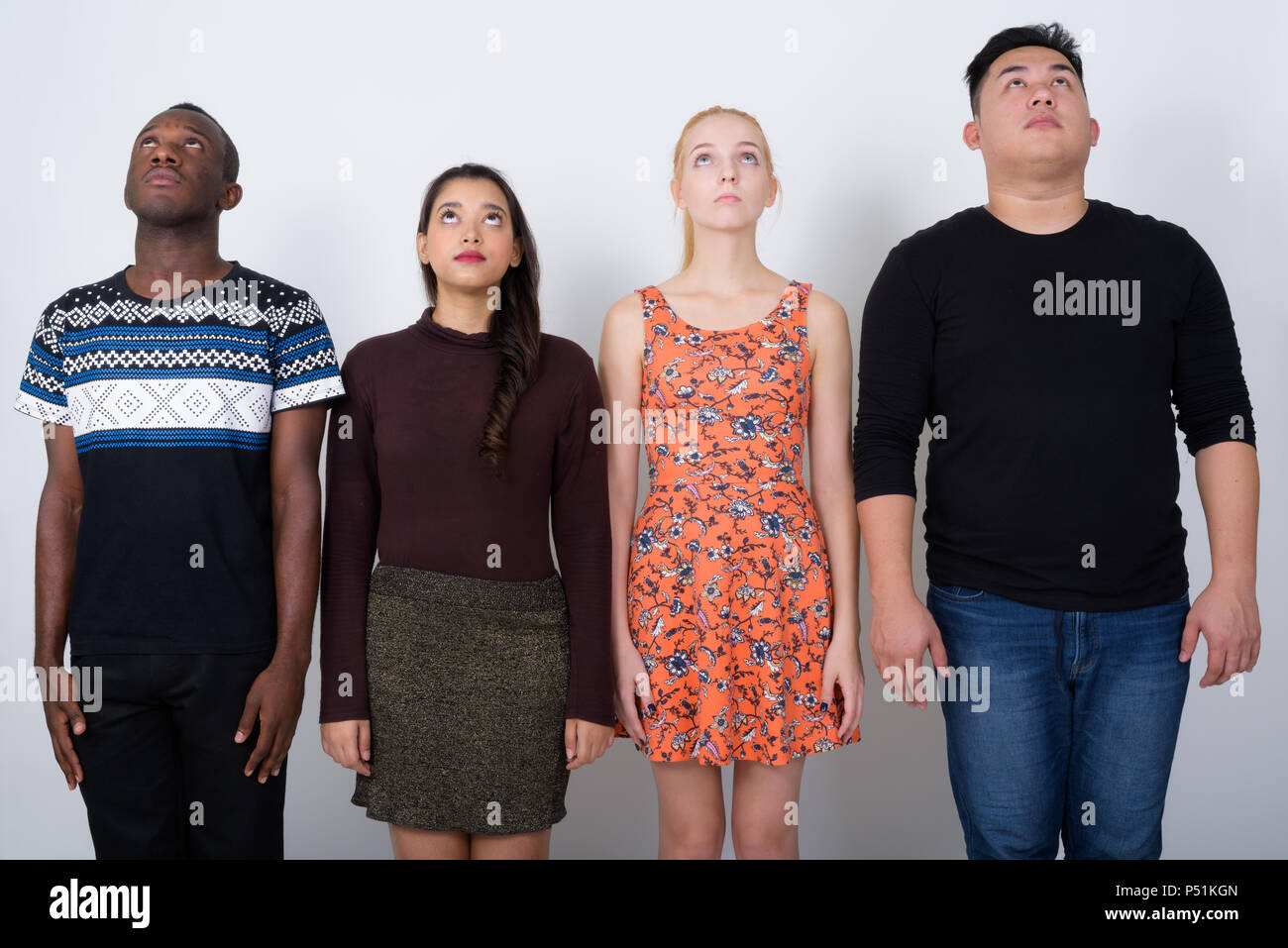 Studio shot of diverse group of multi ethnic friends looking up  Stock Photo