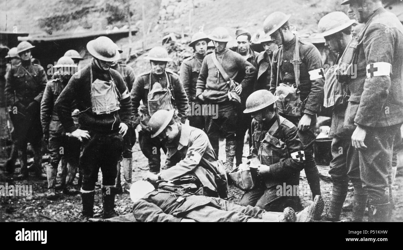 Photograph shows a doctor with an injured American soldier behind the lines in France, during World War I. Stock Photo