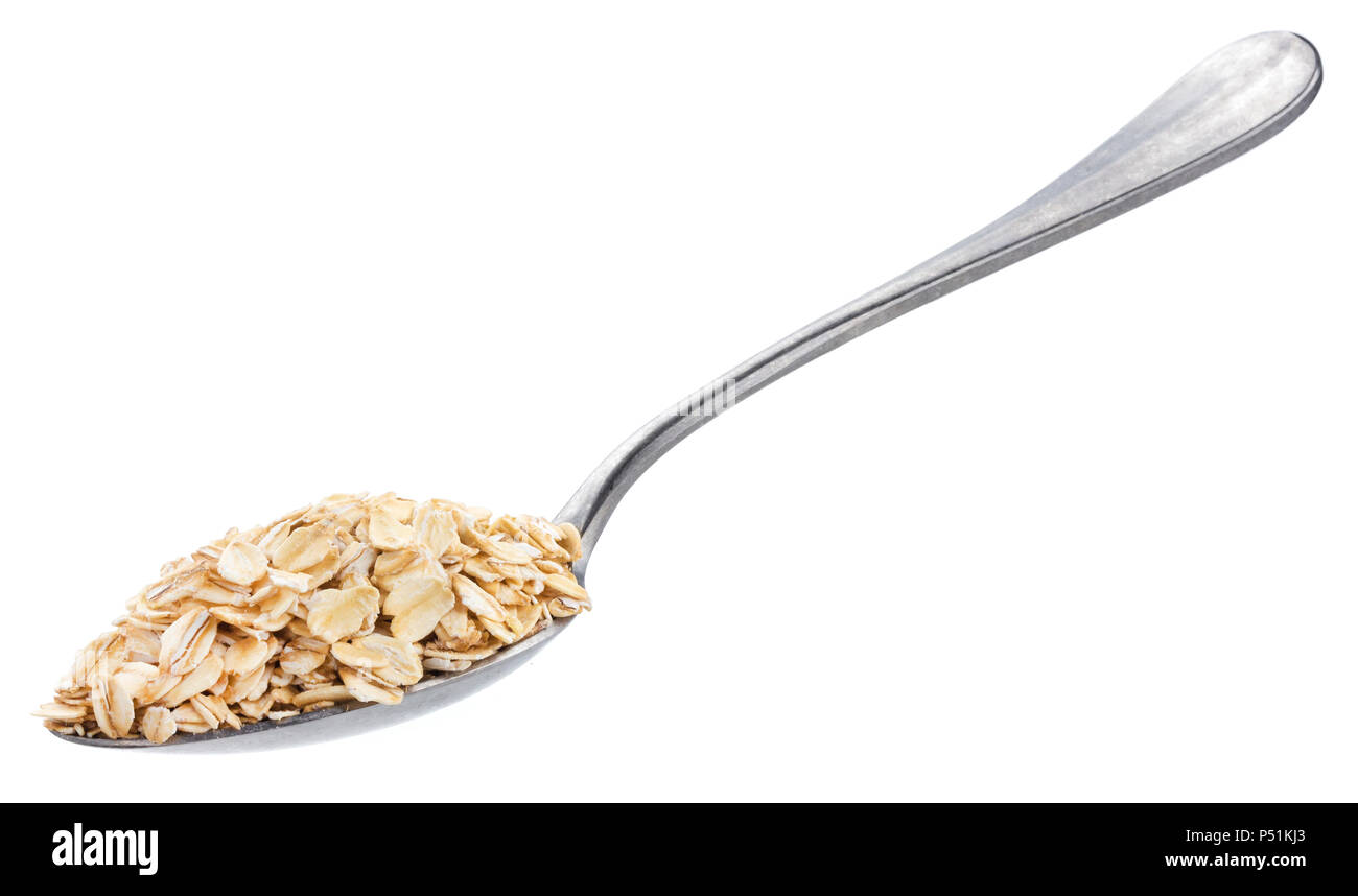 Oat flakes in spoon isolated on white background Stock Photo