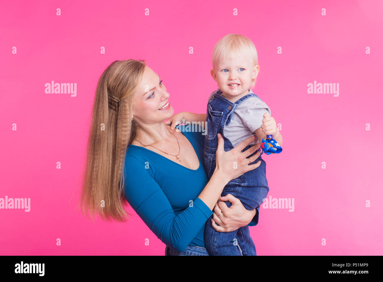 Funny family on pink background. Mother and her daughter girl. Mom and ...
