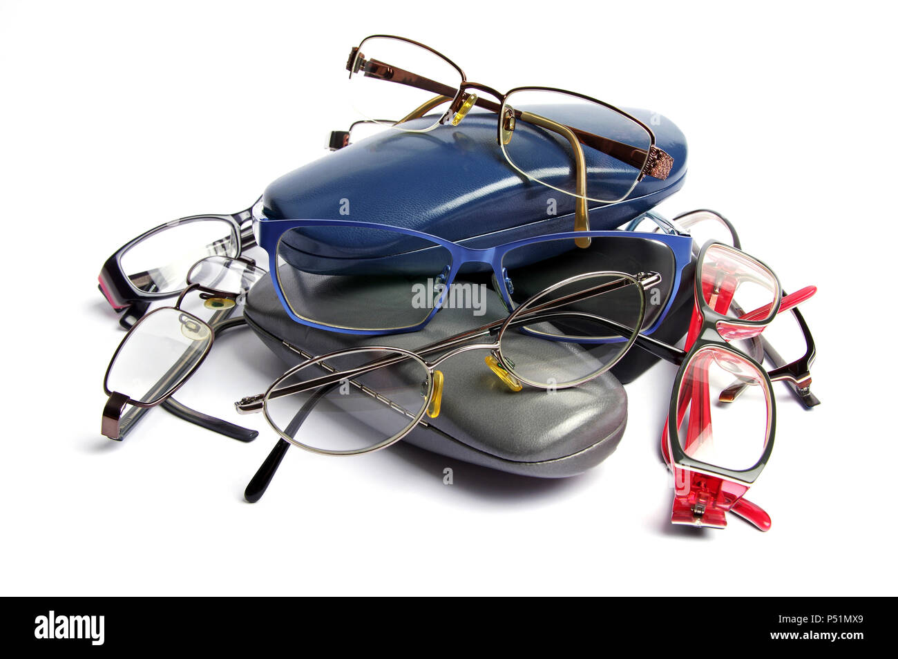 a stack of tangled old coloured reading glasses and glass cases on a white background Stock Photo