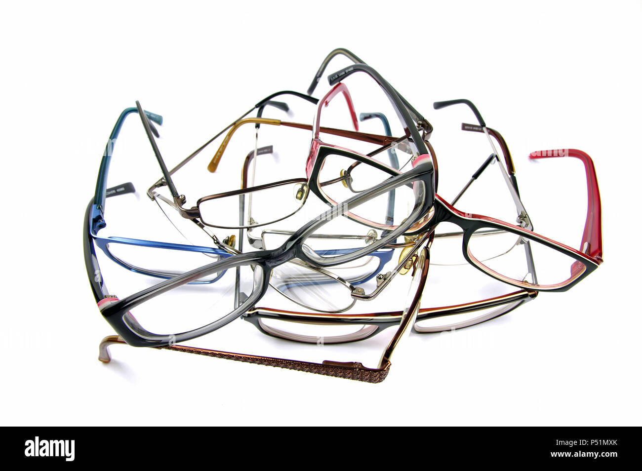 a pile of tangled old reading glasses on a white background Stock Photo