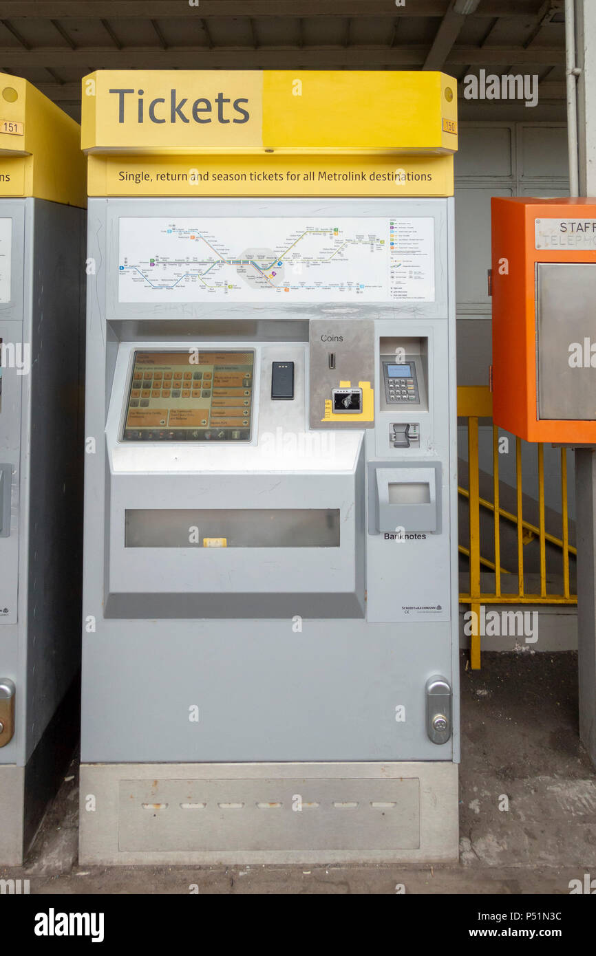 A silver and yellow ticket machine on the platform at Radcliffe metro link tram station which runs between Bury and Manchester. Stock Photo