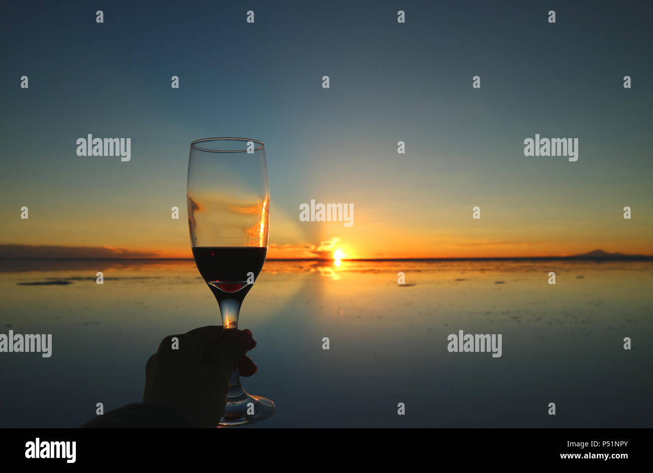 Cheers to the gorgeous sunset on the mirror effect of Uyuni Salt Flats, Bolivia, South America Stock Photo