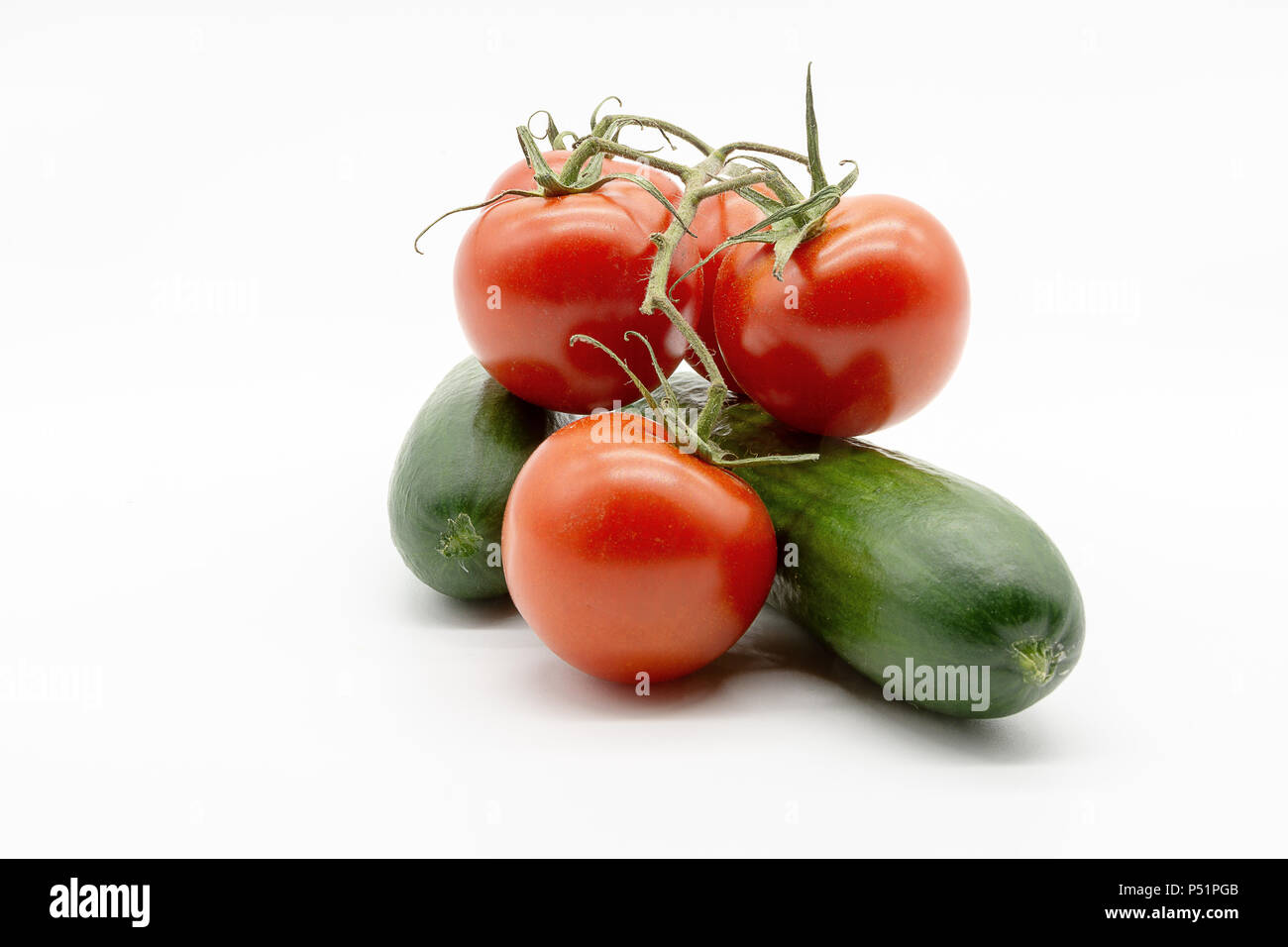 two cucumbers and five tomatoes Stock Photo