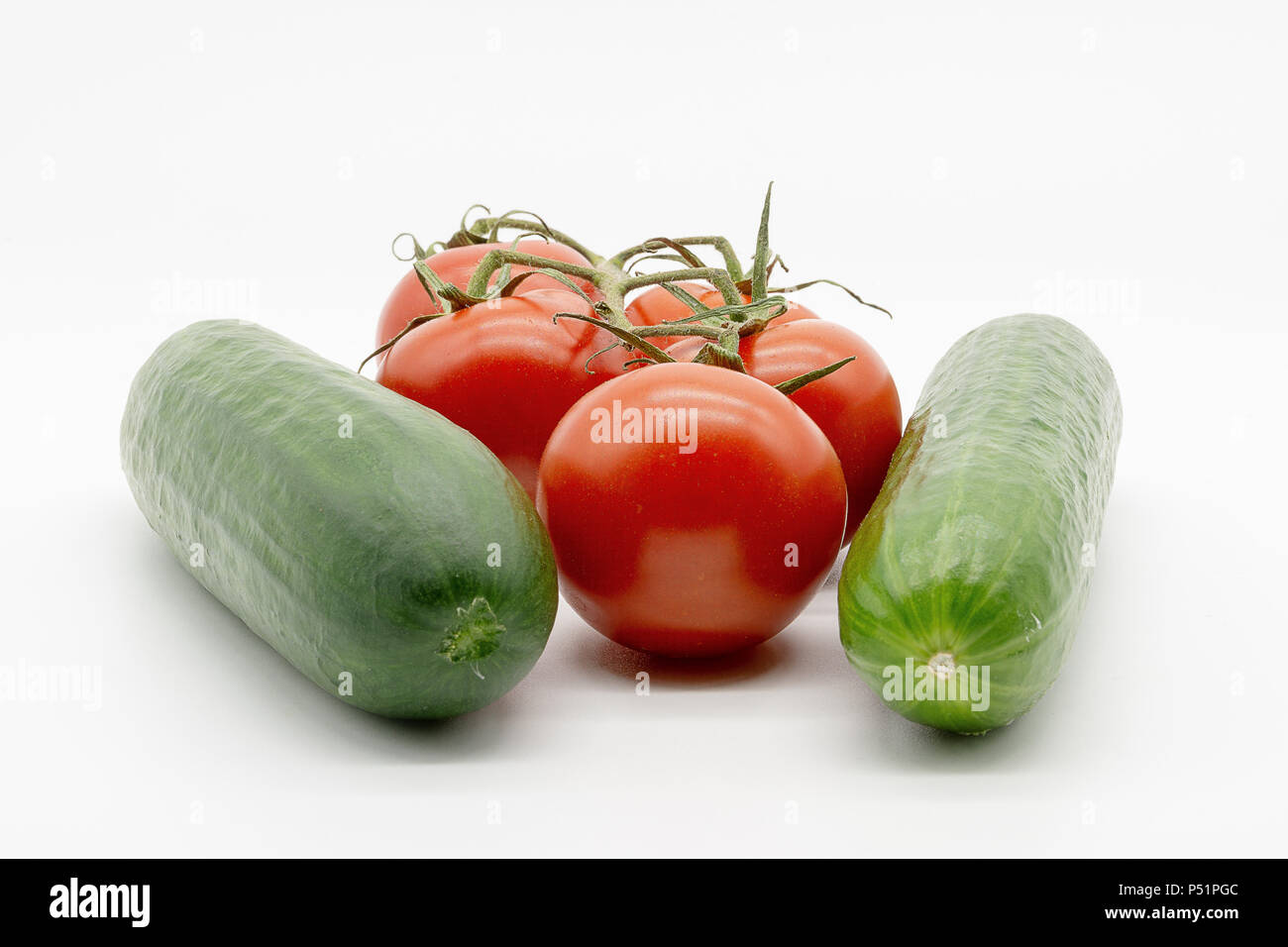 two cucumbers and five tomatoes Stock Photo