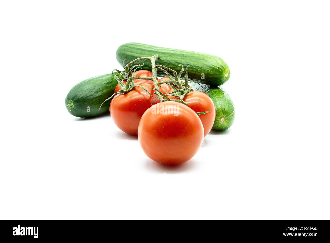 three cucumbers and five tomatoes Stock Photo