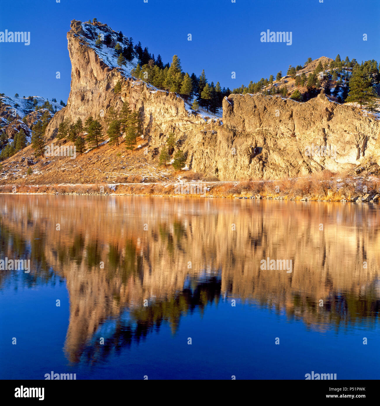 spite hill reflected in the missouri river in winter near craig
