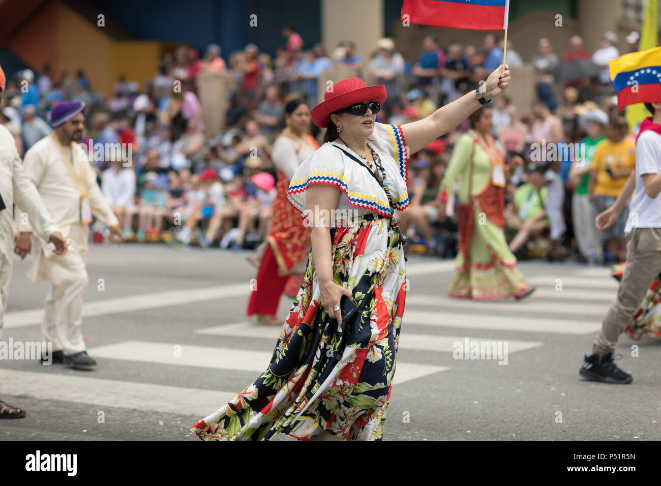 Indianapolis, Indiana, USA - May 26, 2018,  People from different countries with traditional clothing and carrying national flags at the Indy 500 Para Stock Photo