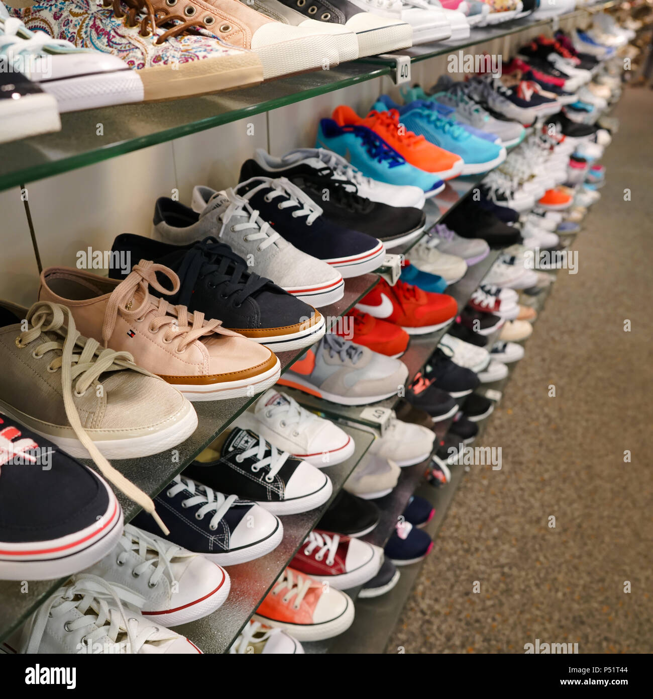Shoes for young people in a shoe store Stock Photo - Alamy