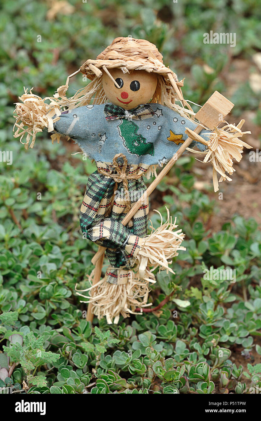 A scarecrow figurine standing in a garden Stock Photo