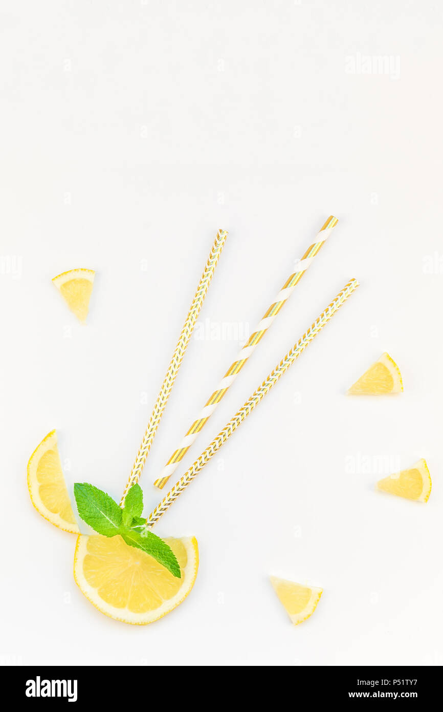 Creative flatlay overhead top view citrus lemon slices and mint herbs leaves white table background with copyspace. Hot summer refreshment lemonade co Stock Photo