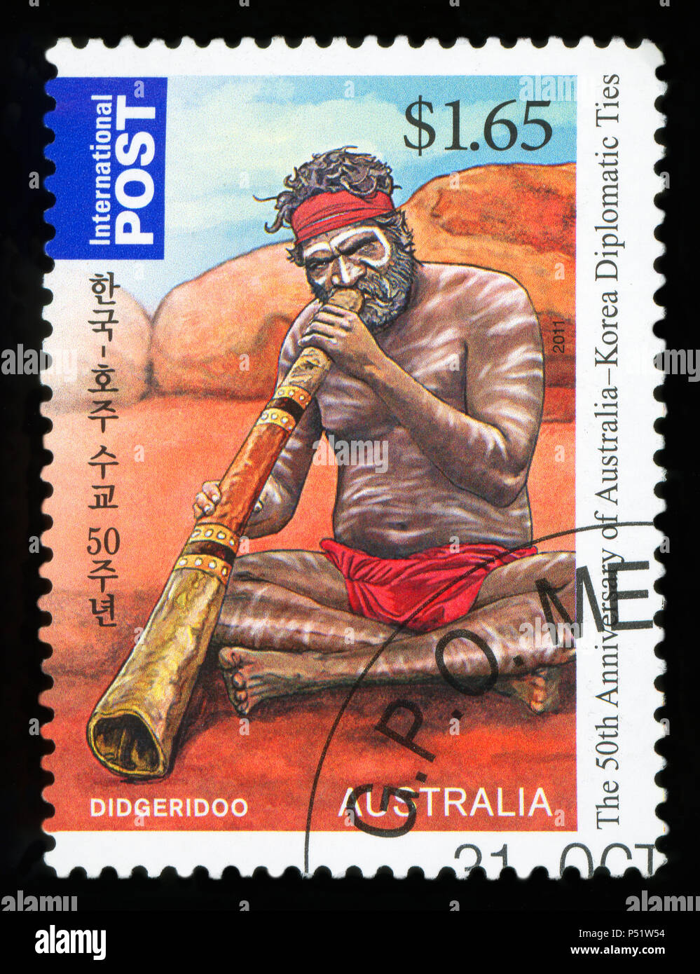 AUSTRALIA - CIRCA 2011:A Cancelled postage stamp from Australia illustrating Aboriginal playing on didgeridoo, issued in 2011. Stock Photo