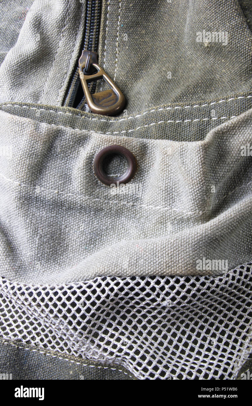closeup of buckles, clasps, zippers, pockets, fasteners, fittings and seams in the green backpack Stock Photo