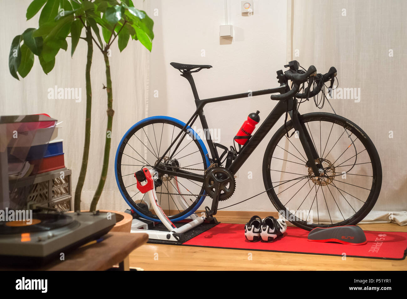 A road bike in a living room on a roll Stock Photo