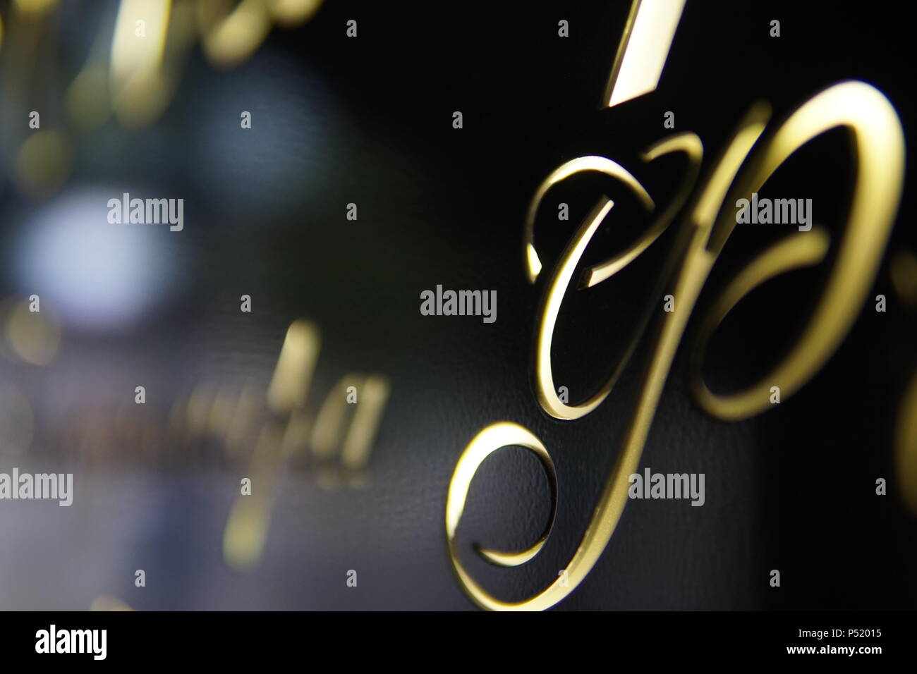 Black sign with Golden glowing letters and figures Stock Photo - Alamy