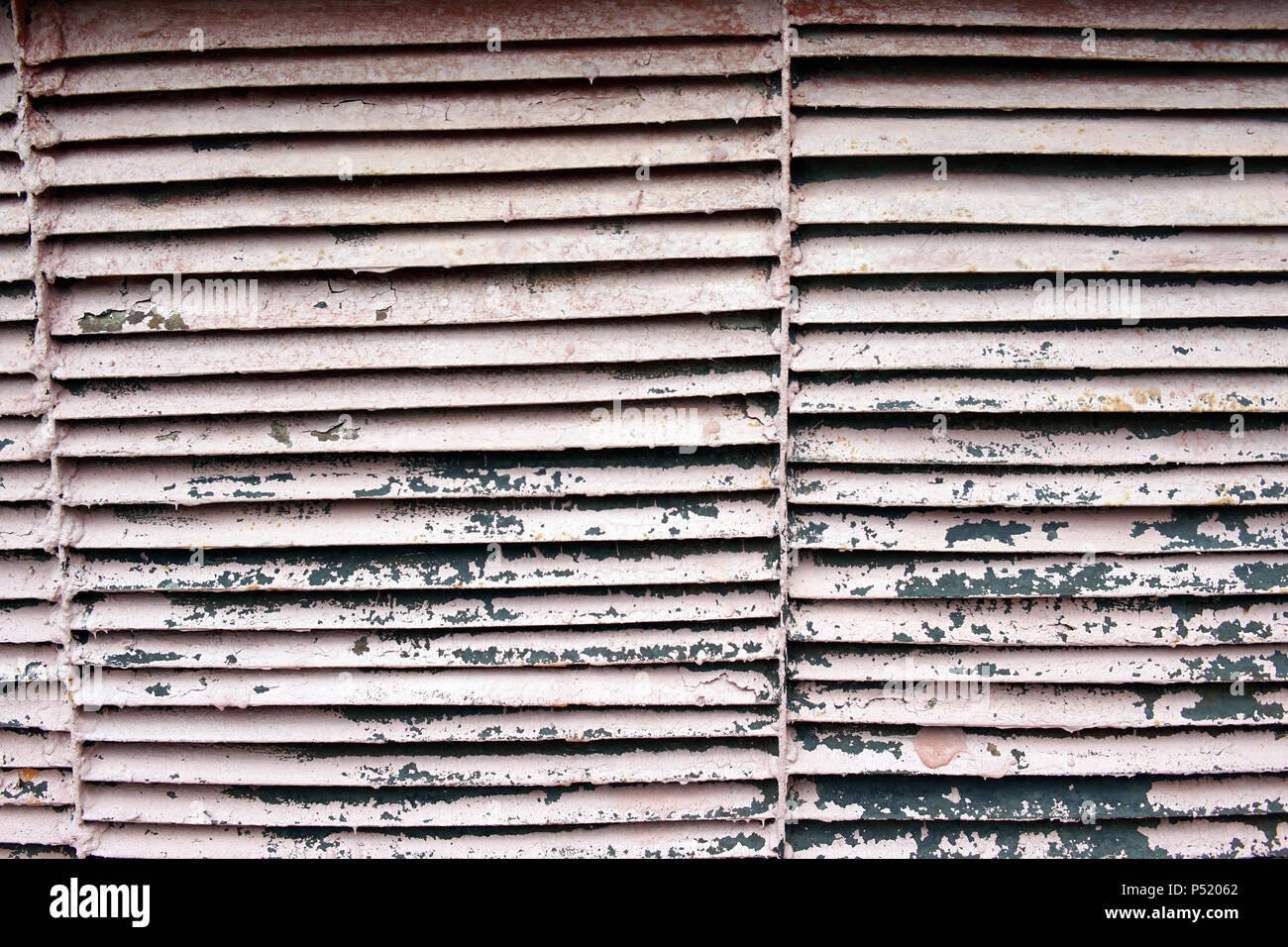 Brick wall with a rusty iron grille in it Stock Photo