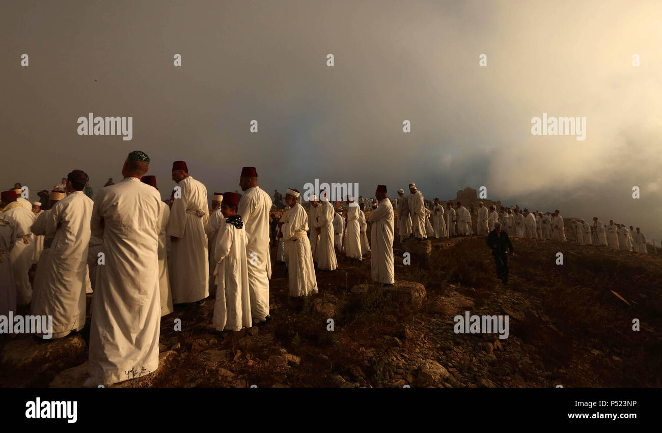 Nablus, West Bank, Palestinian Territory. 24th June, 2018. Samaritan worshipers pray on the top of Mount Gerizim in a traditional pilgrimage to mark the Shavuot's holiday at dawn near the West Bank city of Nablus June 24, 2018 which is giving of the Torah at Mount Sinai seven weeks after the exodus of the Jewish people from Egypt Credit: Shadi Jarar'Ah/APA Images/ZUMA Wire/Alamy Live News Stock Photo