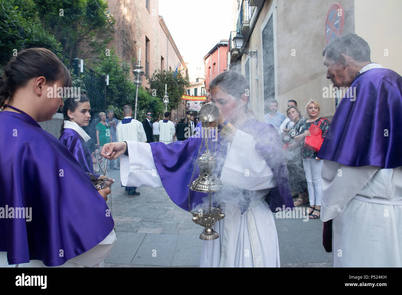 Madrid, Spain. 23rd June, 2018. An altar girls taking incense for her